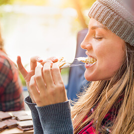 Close up of a woman eating a smore